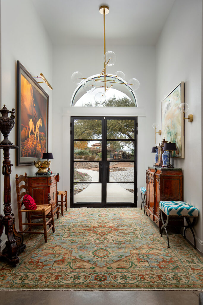 "Bright and colorful San Antonio entry with modern and antique furniture and large windows showing natural light"